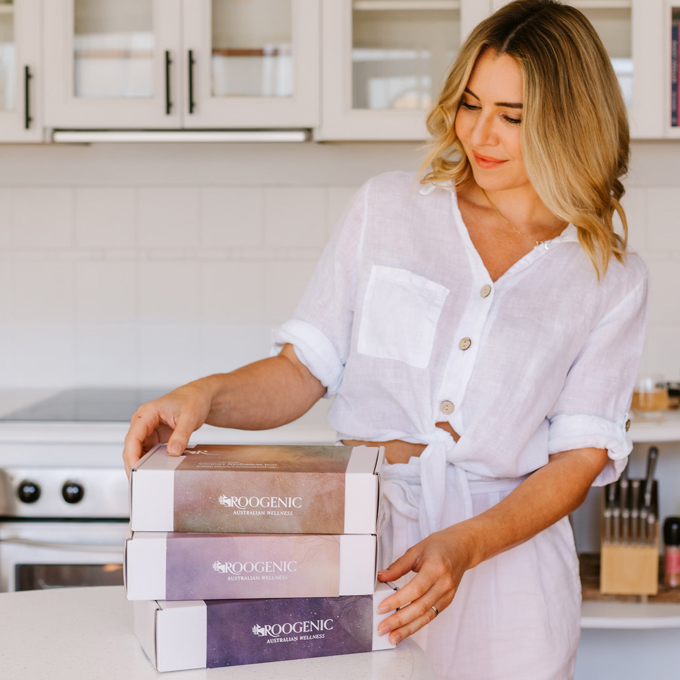 3 gift boxes stacked and admired by female
